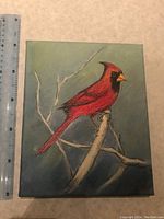 Northern Cardinal painting on canvas with ruler showing size, colors are deep red with muted background and bare branches