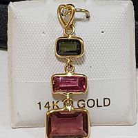 Front view of a 14K gold pendant with three rectangular tourmaline stones and heart-shaped bail with small stone accent.