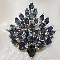 Top view of ring showing cluster of marquise and pear-shaped blue sapphires