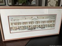 Full view of rectangular framed limited edition print showing winter Christmas street scene with carolers, shoppers, and horse sleighs in front of old fashioned building.
