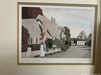 Framed watercolour print titled 'Thatch-Red Cottages' showing quaint English village cottages with a female figure near a gate.