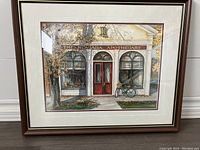 Frontal view of framed print showing storefront labeled 'The Niagara Apothecary', frame and mat