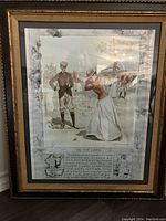 Framed vintage golf poster showing golfers in period clothing on a golf course, with visible rippling and decorative border.