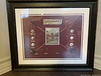 Framed artwork showing vintage golf clubs crossed with golf balls and plaques, along with a golfer illustration in the center.