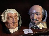 Photo of two Royal Doulton character head mugs, The Lawyer and Shakespeare, showing full frontal views and details.