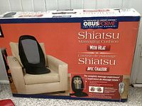 Photo of boxed ObusForme Shiatsu massaging cushion showing product image on armchair and product name.