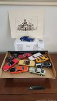 Full view of all model cars in a box, blue Winross truck displayed on a white box above with a vintage illustration.