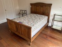 Angled view of assembled bed frame with mattress, showing overall structure.