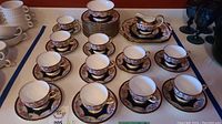 Overview of teacups, saucers, plates, creamer, sugar dish, and platters arranged together