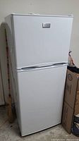 Frigidaire refrigerator full front view showing two doors and white finish.