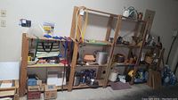 Wide side view showing full shelving unit with shelves and frame, natural wood finish, and items on shelves for scale.