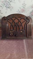 Front view of wooden cabinet Westinghouse antique tube radio showing speaker grille and knobs.