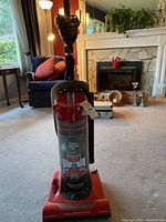 Front view of Dirt Devil Power 2600 upright vacuum cleaner showing its design and dust canister.
