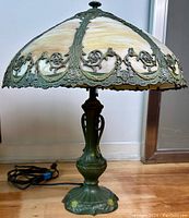 Full view of lamp showing slag glass shade and cast metal base