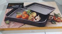 Photo of boxed Kitchen Elements 4-piece roaster set, showing pans with tomatoes and garlic for scale.