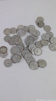 Scattered view of 56 circulated silver quarters