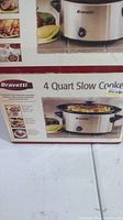Photo of the Bravetti slow cooker in its original box showing the slow cooker on countertop with control knob and stoneware insert pictured on box.