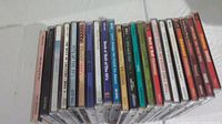 22 CDs lined up showing the spines and some covers, including titles and artists.
