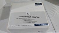 Packaged box of Queen size white sheet set labeled 'Super Soft Solid Sheet Set' from Boutique Collection with item details.