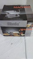 Photo showing the Shule pasta machine original packaging box with product image and branding