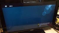 Front view of Sony TV screen powered on, showing HDMI no signal message