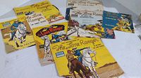 Seven paper sleeves and records from The Lone Ranger children's series records by Decca, showing illustrated outer sleeves with various wear and tears.
