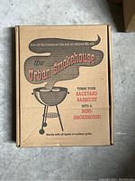 Cardboard box with Urban Smokehouse branding promoting turning a backyard barbecue into a mini smokehouse.