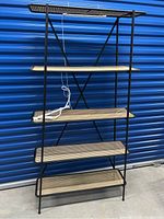 Front view of the metal frame bookcase with five rattan shelves and two plant lights on middle shelves.