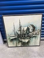 Full view of the framed ship painting showing boats docked near buildings on water with soft color palette.