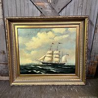 Frontal view of the framed oil painting depicting a two-masted sailing ship at sea.