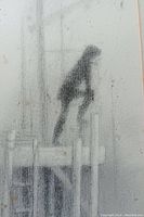 Close-up of the charcoal drawing showing the figure and texture of charcoal medium with stains.