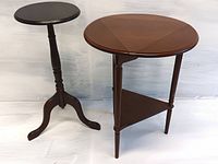 Both the drop leaf triangle-to-round table and the round plant stand are shown side by side. Drop leaf table has a dark wood finish with a triangular shelf beneath and four legs. Plant stand has a turned pedestal and three legs with a round top.