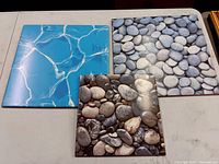 Three ceramic photo tiles arranged showing water ripple and two stone prints