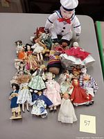 Group photo of 18 dolls showing variety of international and heirloom styles, assorted costumes and sizes from 4 to 10 inches.