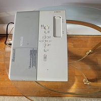 Top view of white Epson projector showing control panel and power button area.