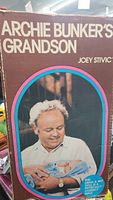Photo of original box showing image of Archie Bunker holding baby doll wrapped in blue blanket and text 'Archie Bunker's Grandson Joey Stivic'.