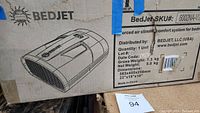 Box with BedJet branding, showing product schematic and dimensions, indicates model V2 and dual zone climate control system for beds.