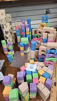 Photo showing stacked colorful foam blocks in pastel colors and wood tone with different shapes including arches and cylinders