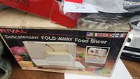 Box of RIVAL Delicatessen Fold-Away Food Slicer showing branding and product image