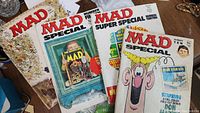Four MAD Magazine issues including various Special and Super Special editions arranged together.