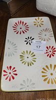 Full view of rectangular ceramic platter showing colorful floral patterns on white background.