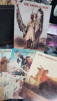 Close-up of three magazine covers showing Native American, cowboy, and horse rider artwork from The American West series.