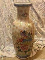 Front view of the oriental floor vase showing the bird and flower artwork.