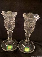 Pair of clear Waterford Crystal Marquis candlesticks showing the intricate cut crystal design and flared tops.