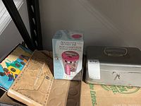 Photo of the unopened digital coin counting money jar box and aged small metal cash box with key.