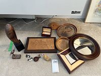 Overall view of all wood decor items including bust, birds, sketch, mirrors, boxes and framed image