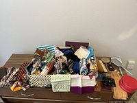 Overview of all items on the table including scarves, purses, gloves, fan, brushes, and vanity mirror.