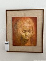 Framed oil painting on board showing a woman's face in warm browns with texture.