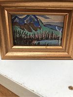 Frontal view of miniature framed painting showing mountain landscape with trees, hills, and water in blue, green, brown and black tones with Sid Mooney signature.