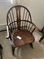 Full front view of Windsor rocking chair showing spindle back, arms, seat and rockers